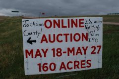 Sign-by-Interstate-with-exit-ramp-in-view_web