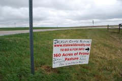 Sign-by-Interstate-with-road-in-view_web